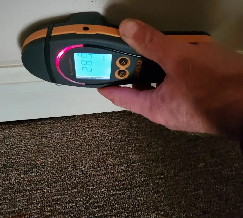 Moisture detection at baseboard during Storm Damage Restoration in Monmouth